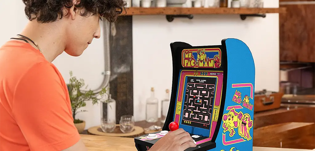 Person playing standing arcade game