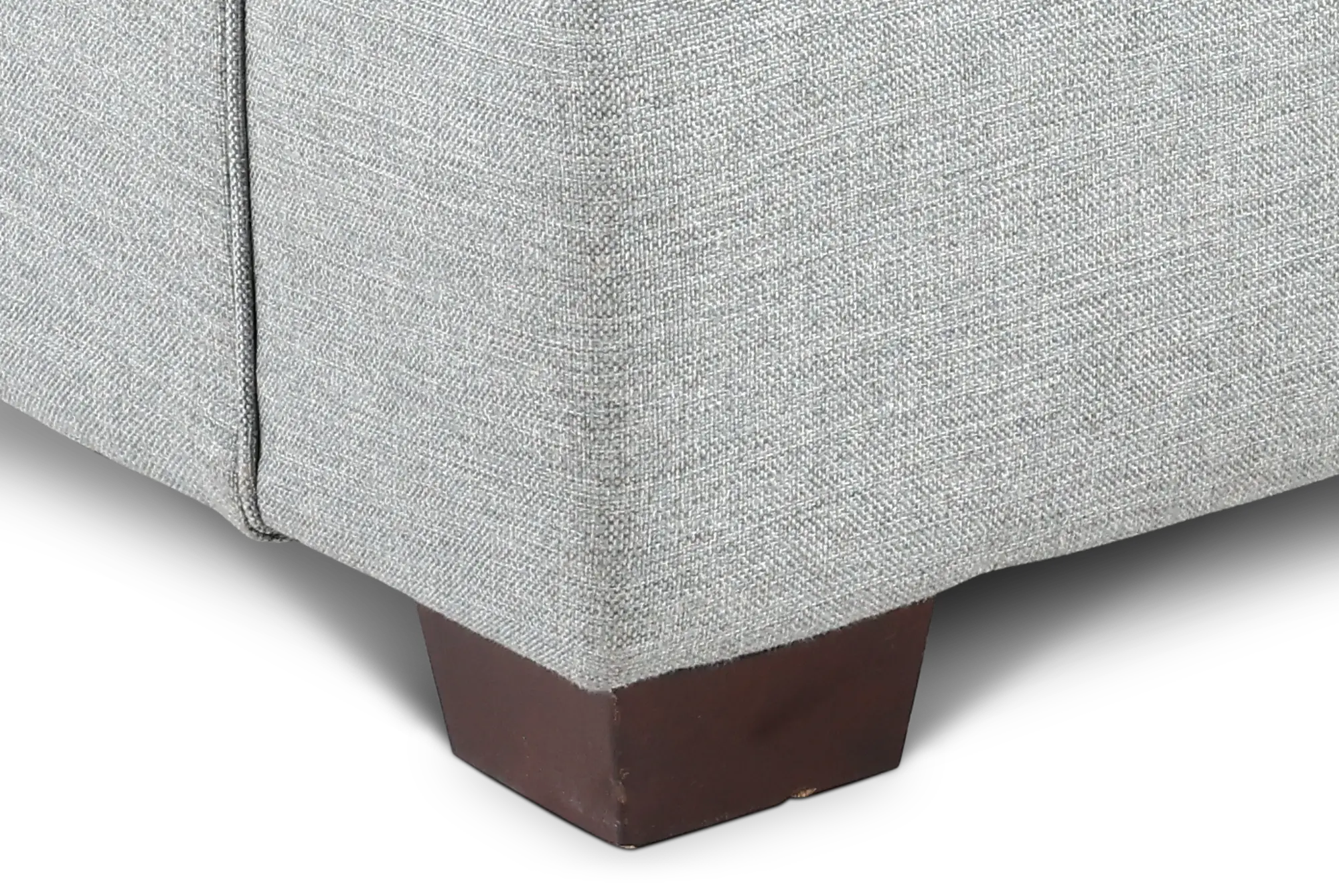 Close-up of the chair’s fabric weave on a leg, showing the brown wooden leg