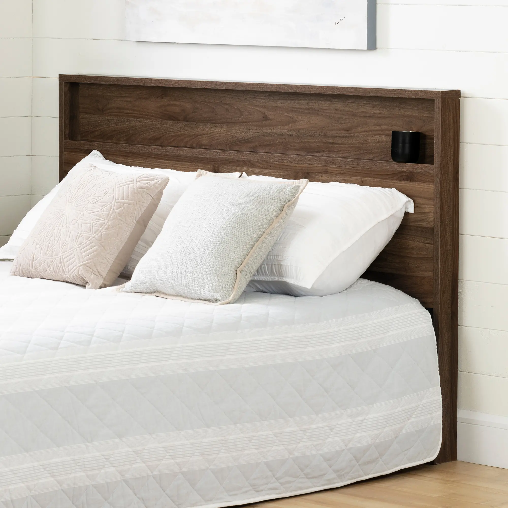 Close-up of dark wood nightstand with built-in shelf showing a black cup