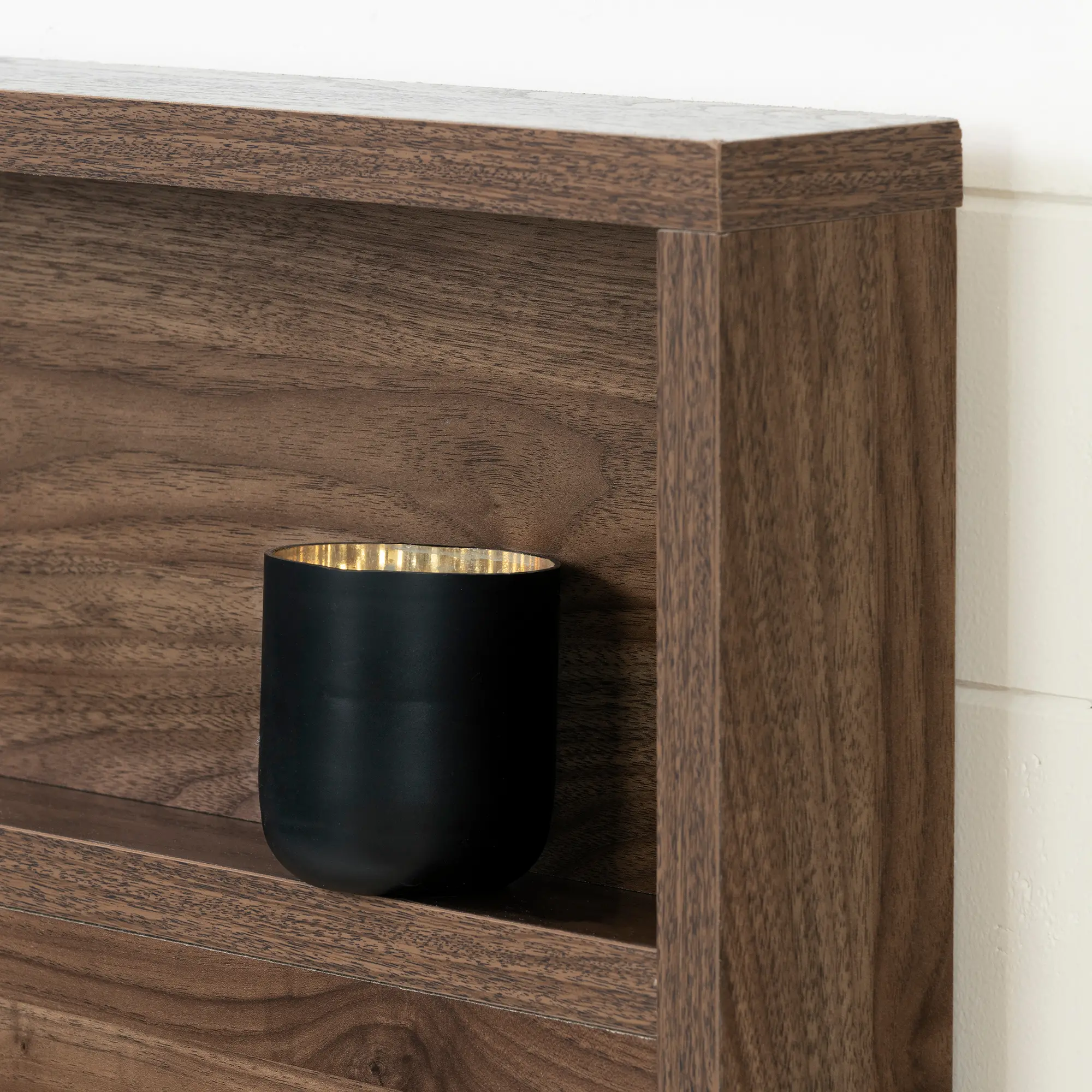 Corner of wooden bed headboard showing joint and wood grain