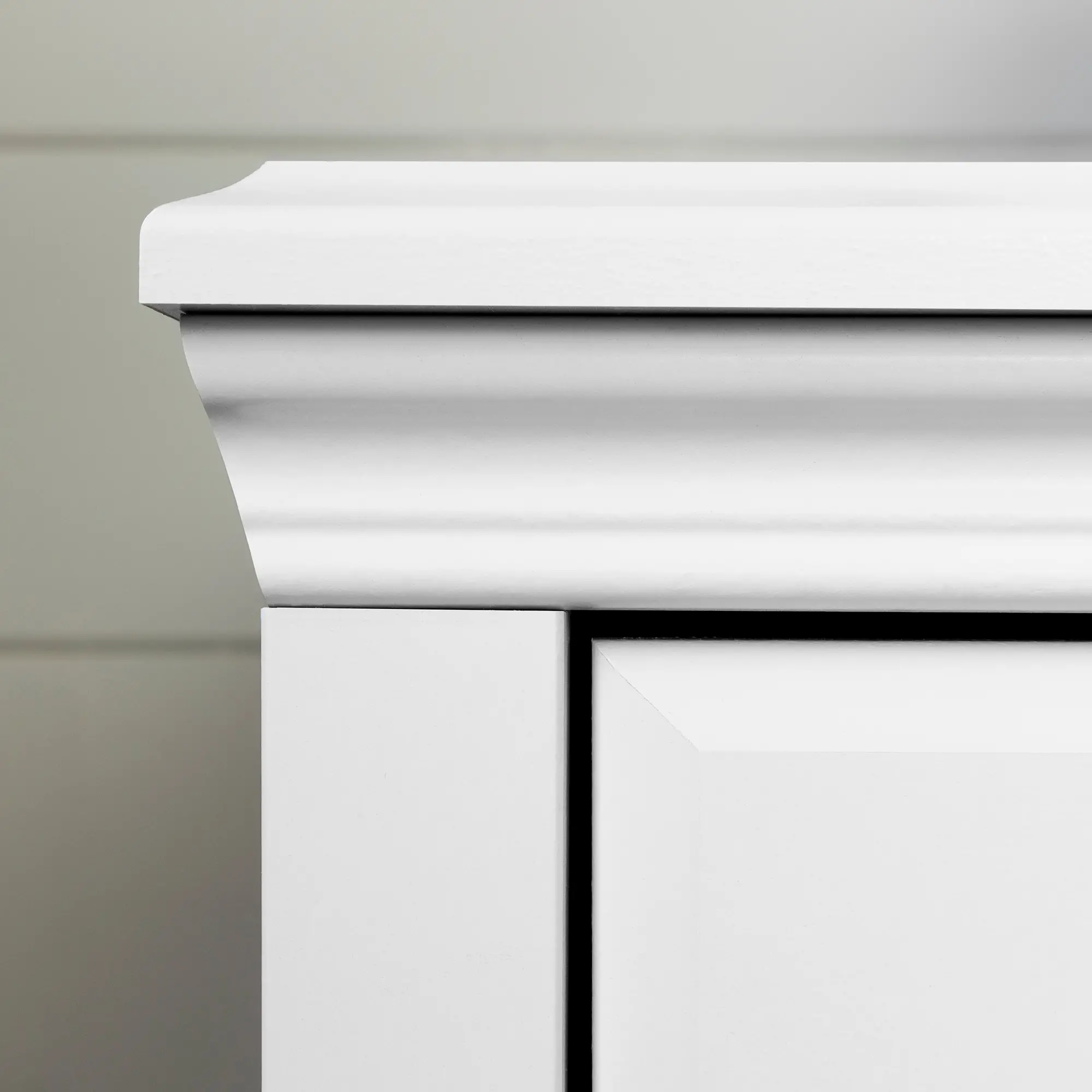 Close-up of the dresser top molding and corner detail.