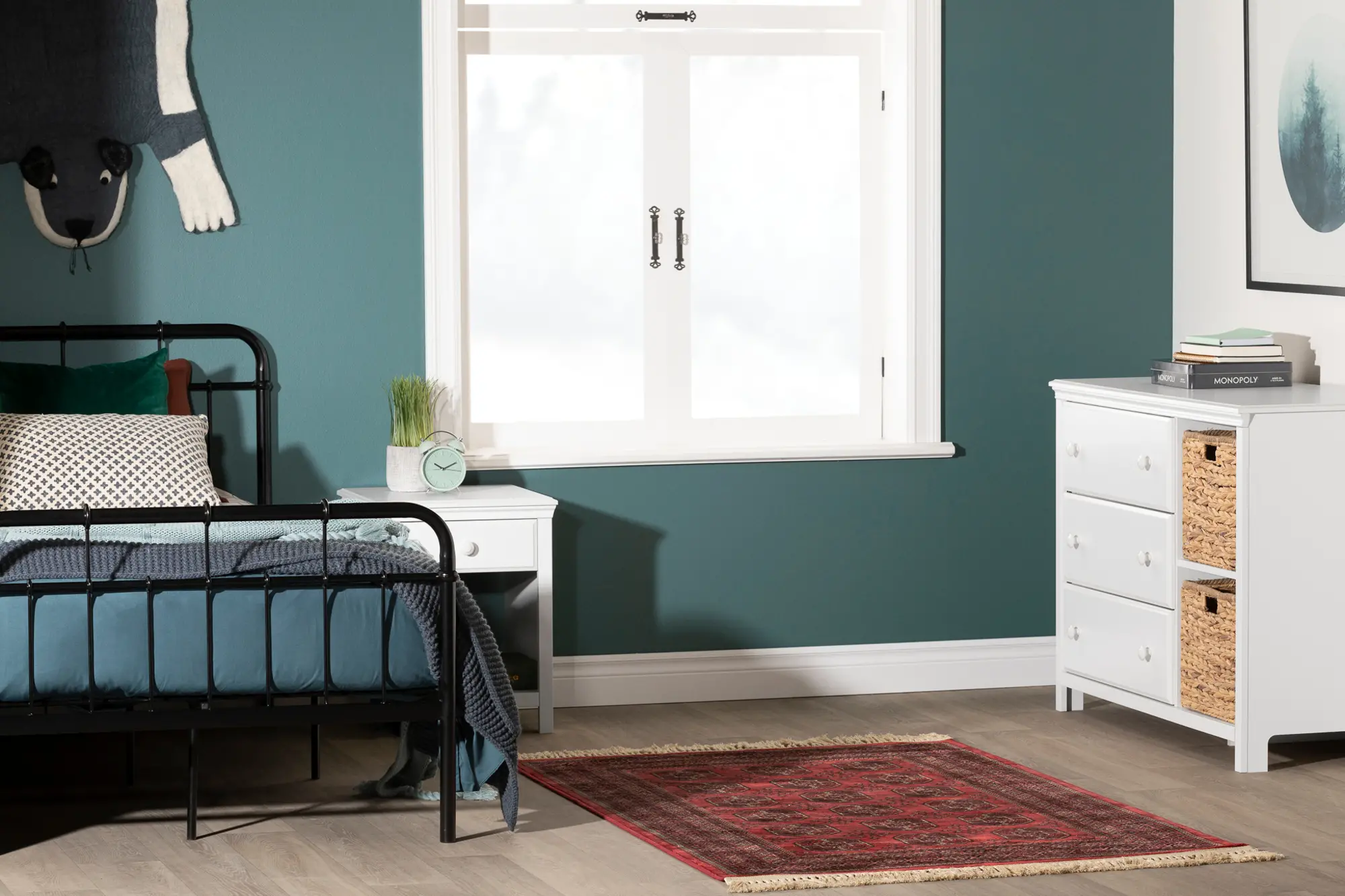 Wide view of child’s room showing bed, nightstand, dresser with baskets, and window.