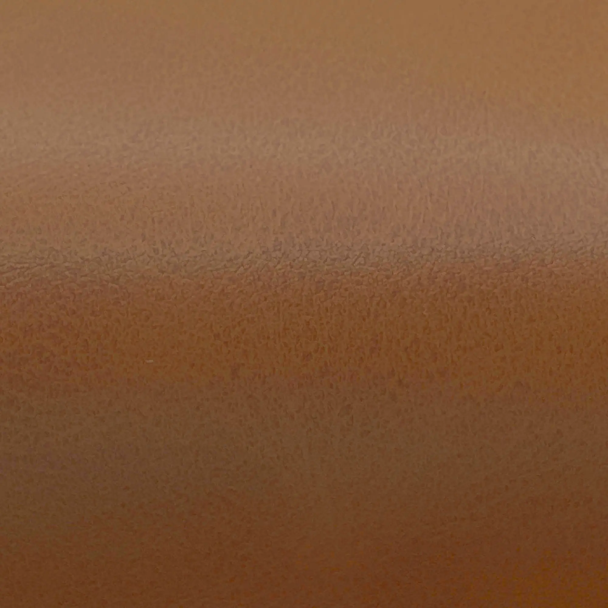 Close-up texture image of brown leather showing grain and surface finish