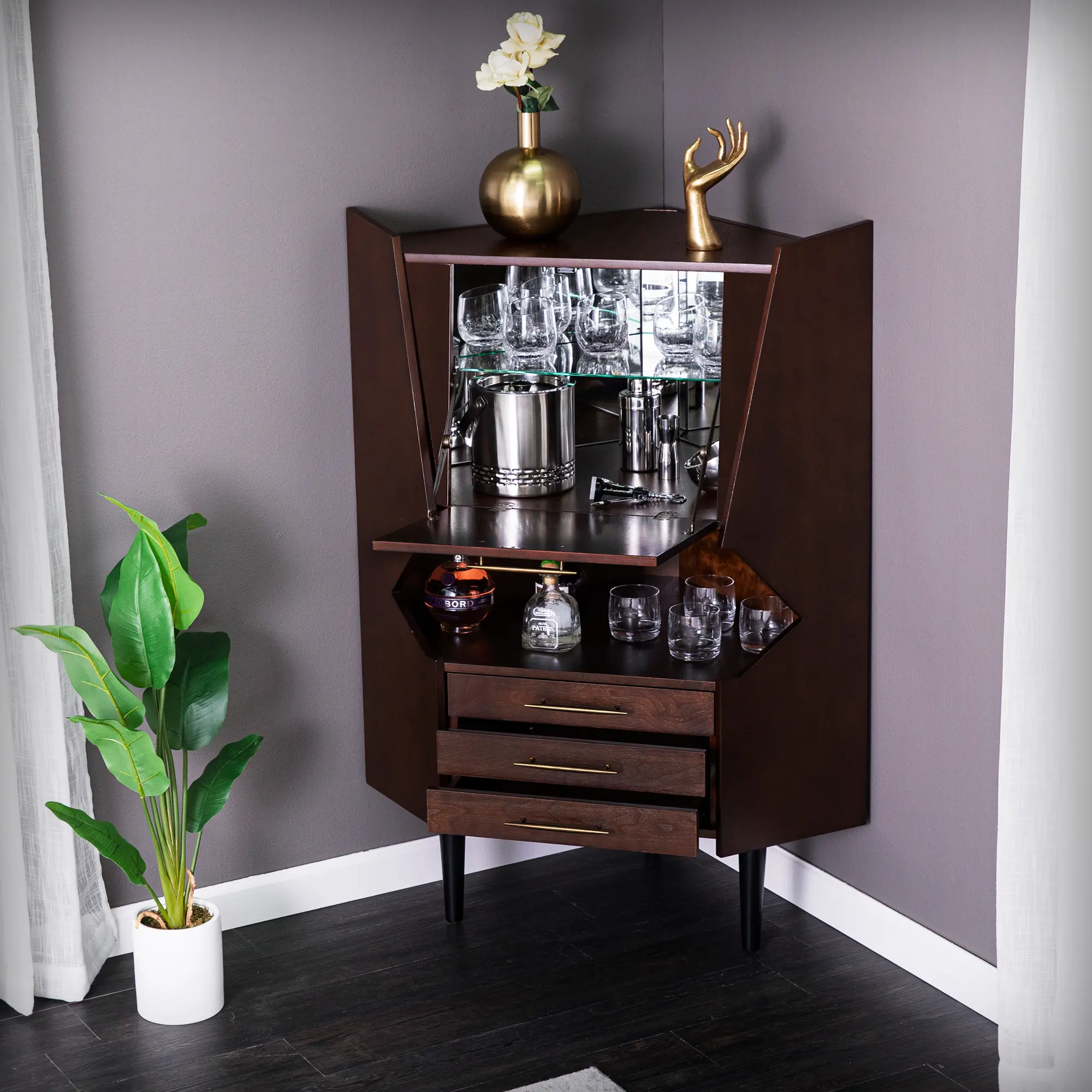A dark brown vintage-style cabinet with upper glassware storage, doors open showing shelves, and drawers below.