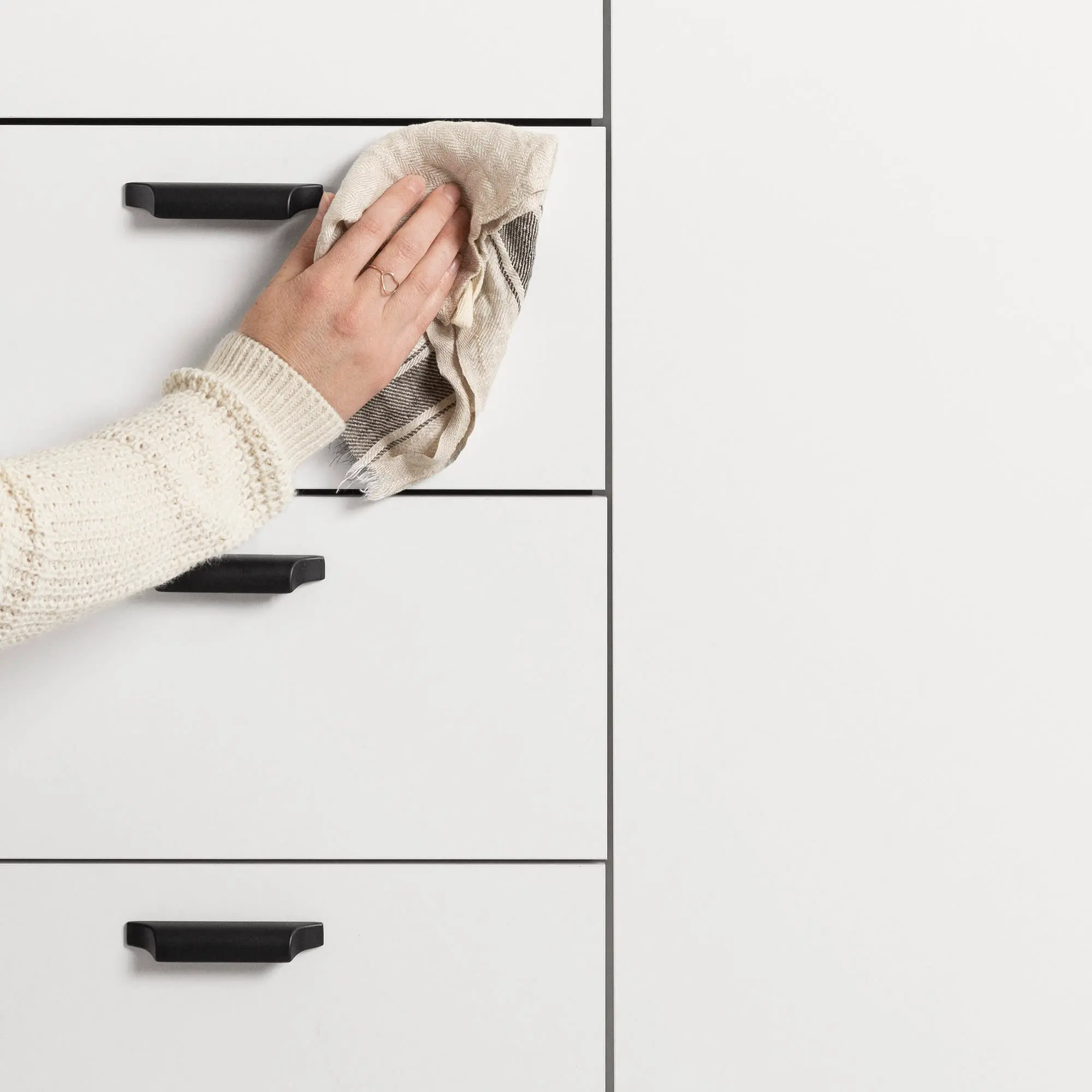 Open drawer section showing multiple white drawers with beige interiors and cutlery trays.