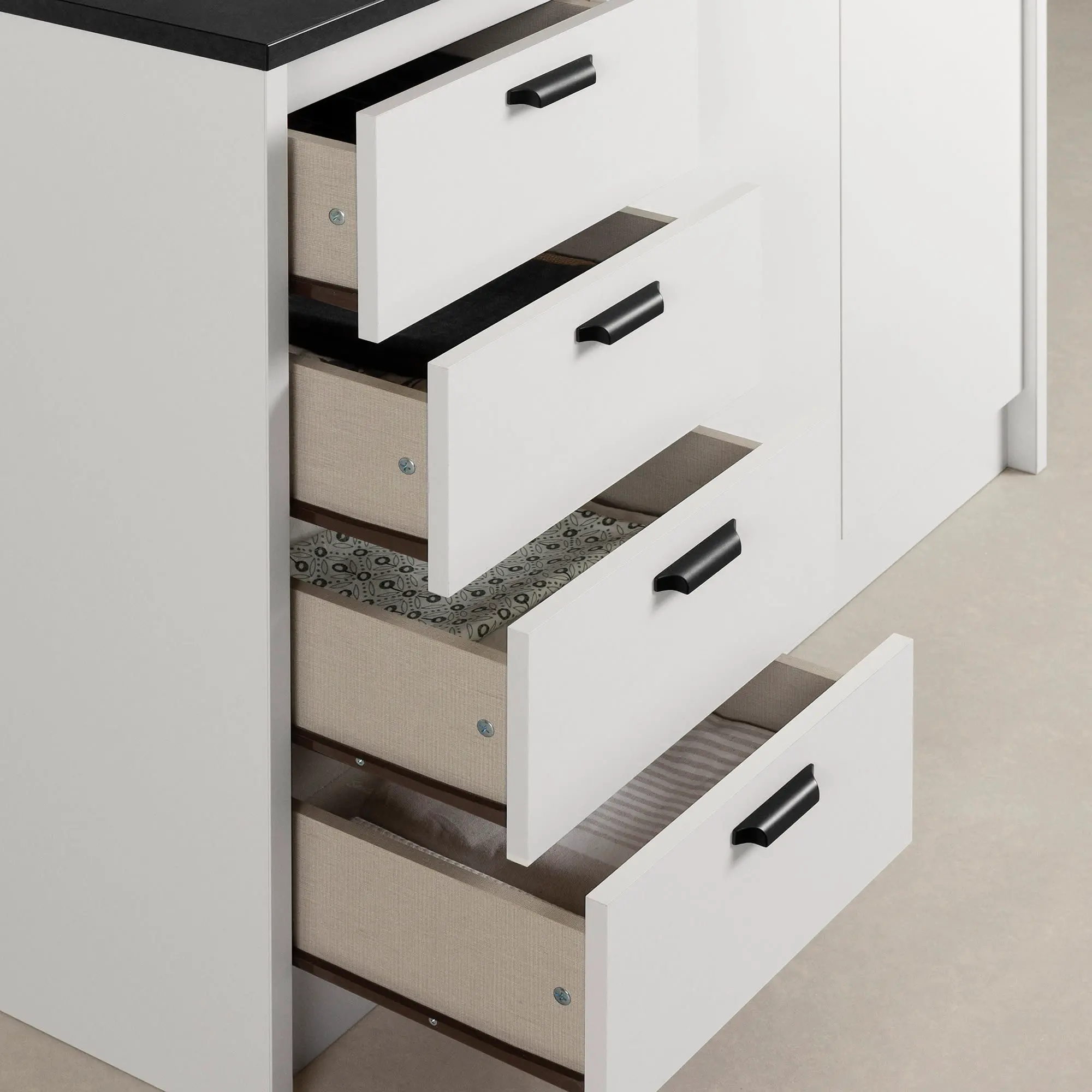 Open drawer with cutlery organizer filled with forks and spoons.