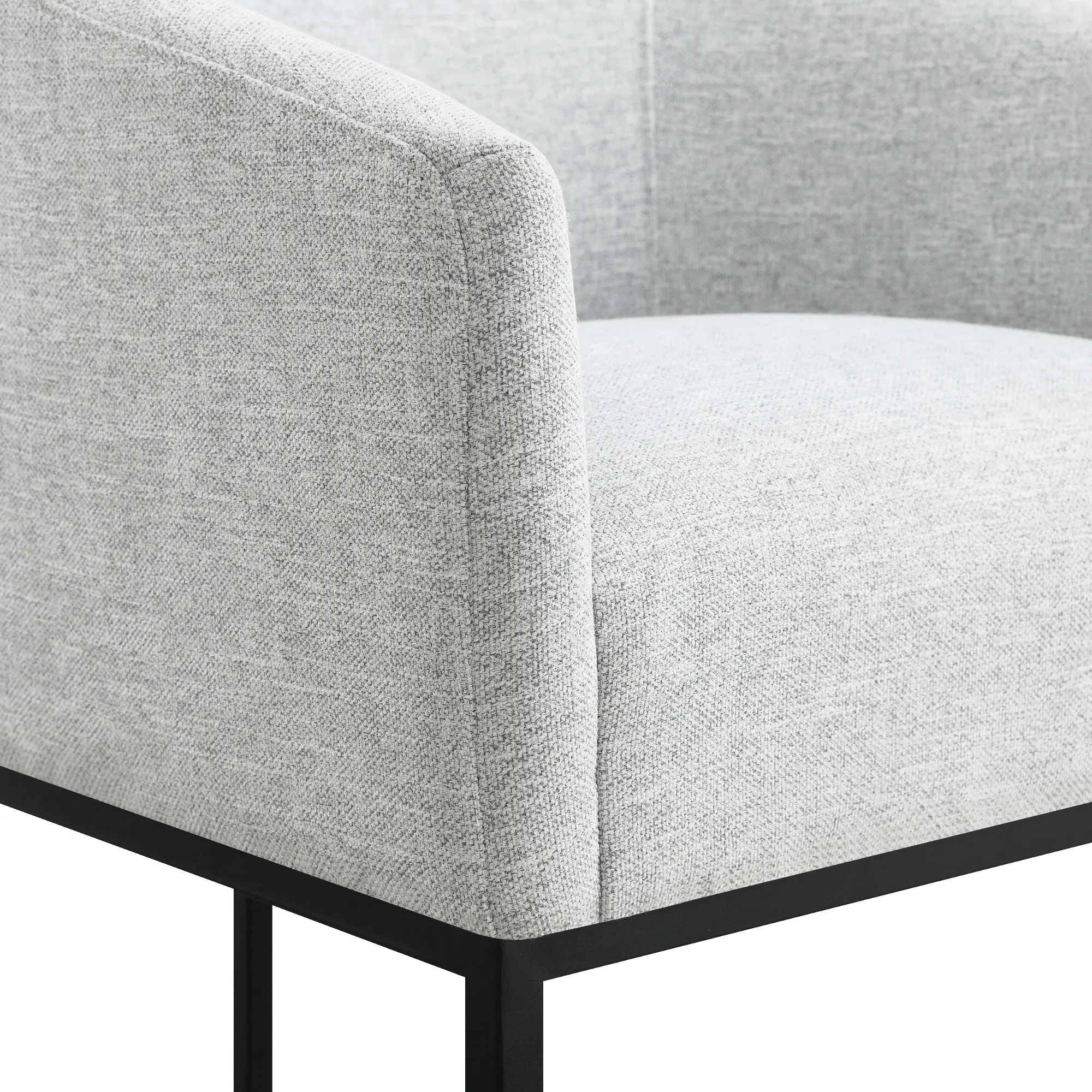 Close-up of the arm of the grey upholstered bar stool with black metal base.
