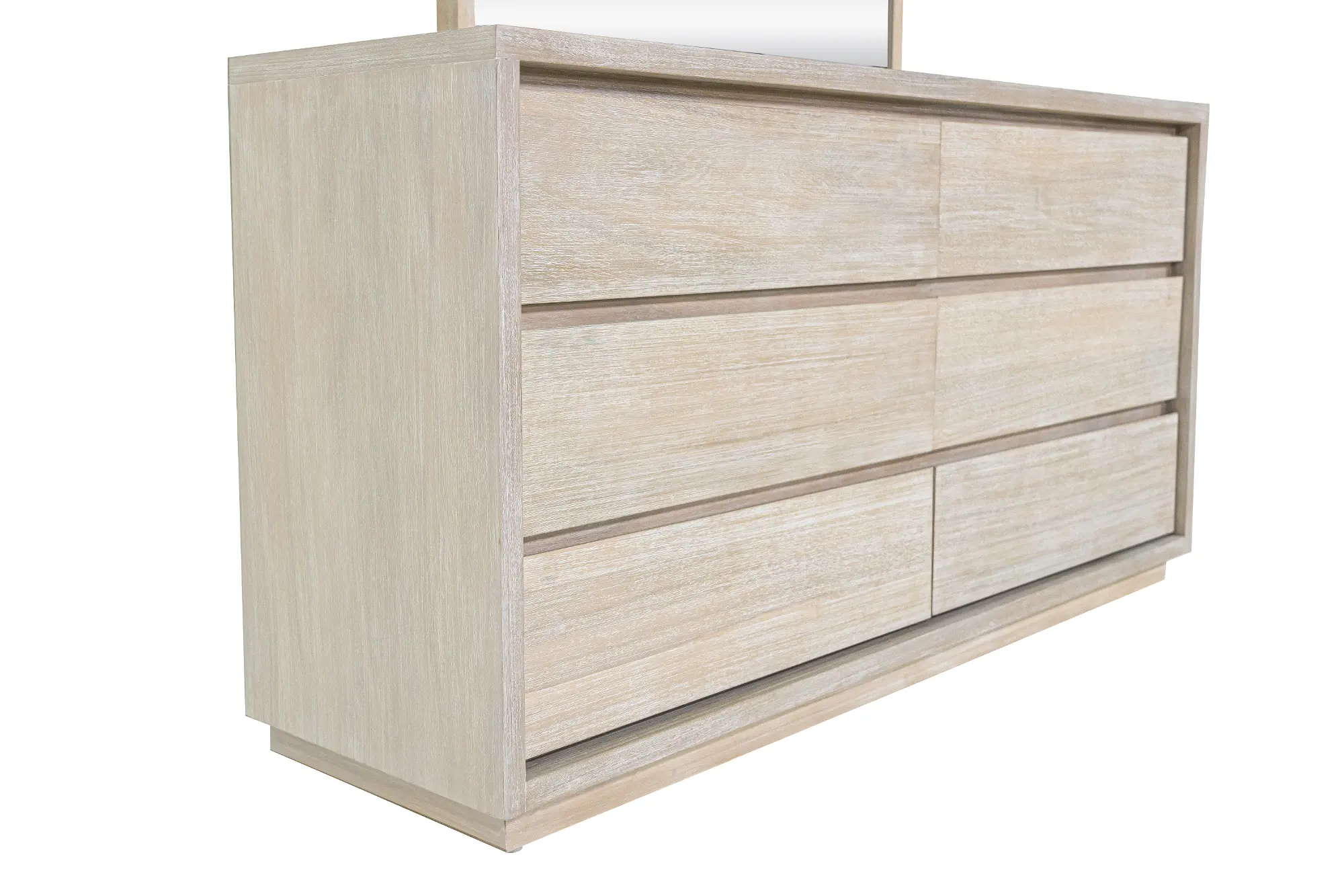 Close-up side view of a light wood dresser showing top surface and drawers.