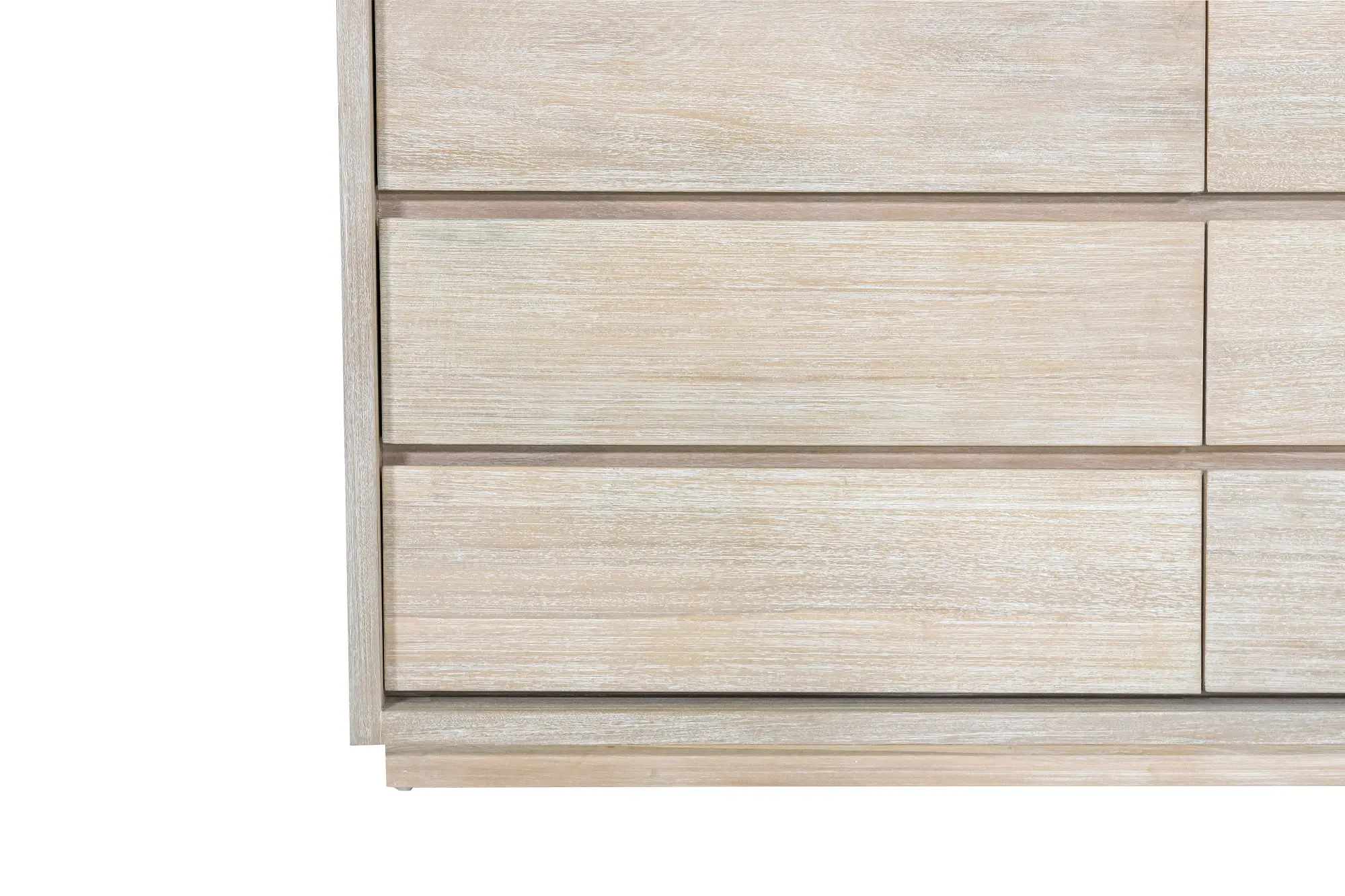 Close-up of the front of a light wood dresser with horizontal drawers and wood grain.