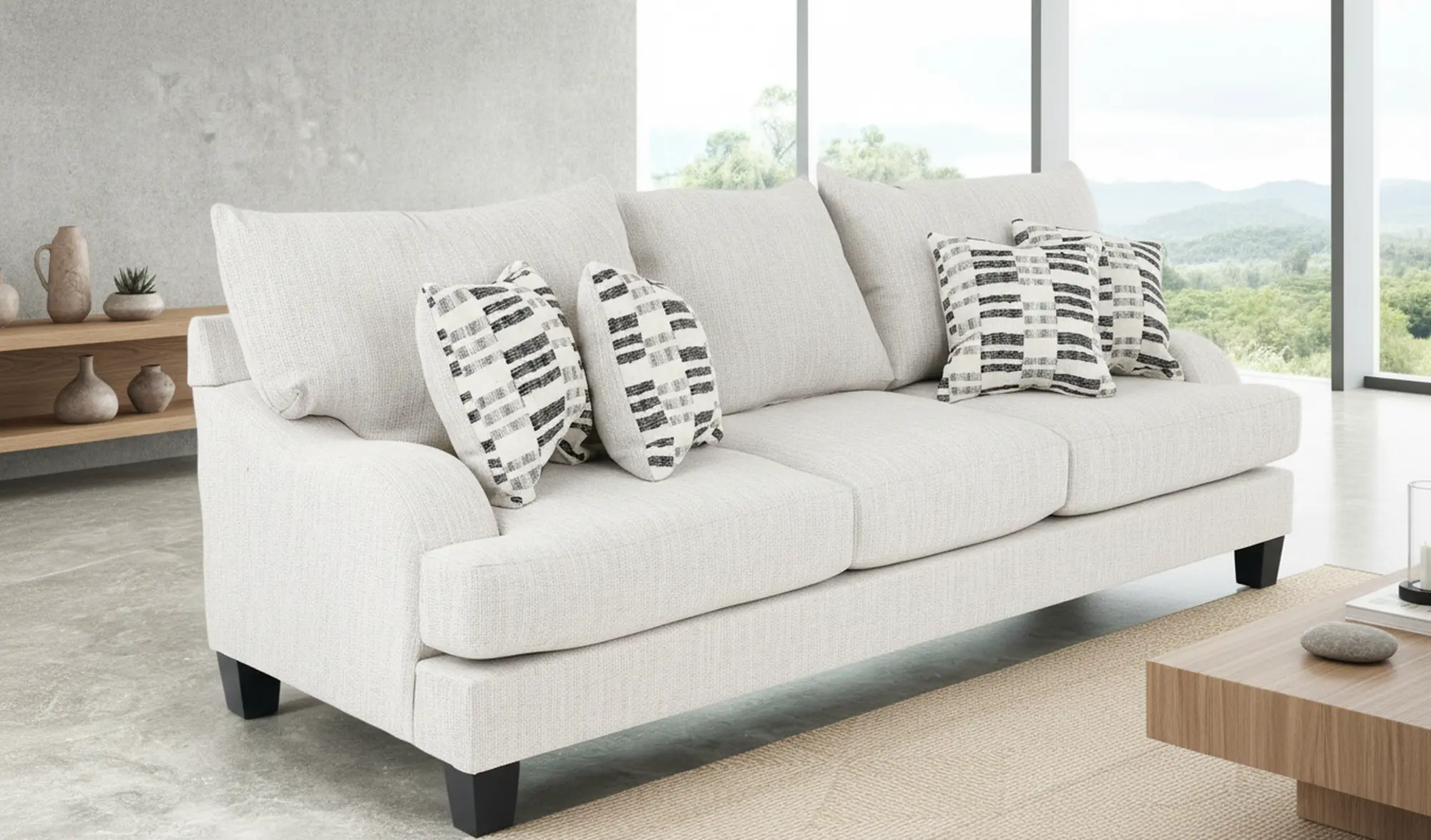 Close-up of a light beige sofa with three-seat and striped throw pillows